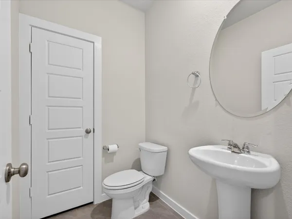a bathroom with a sink toilet and a mirror