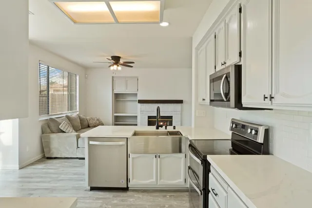 a kitchen that has cabinets a sink and a stove