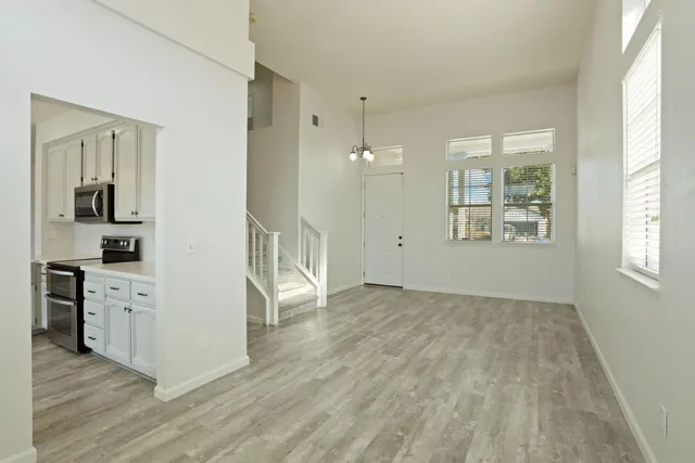 a view of a kitchen cabinets and wooden floor