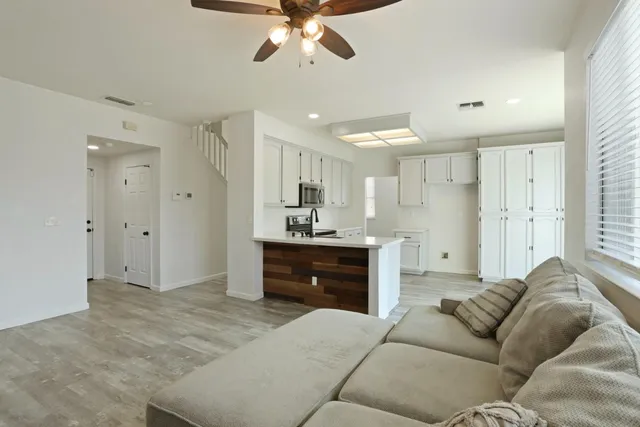 a living room with a couches and chandelier