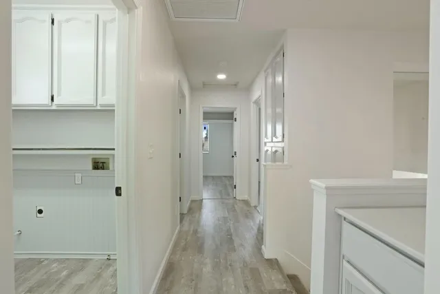 a view of a hallway with wooden floor