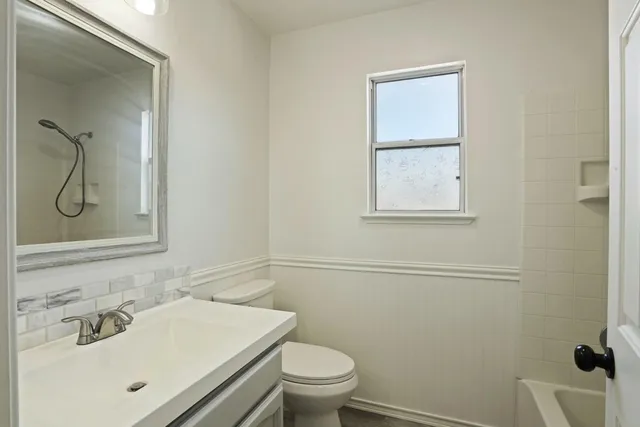 a bathroom with a sink toilet and vanity