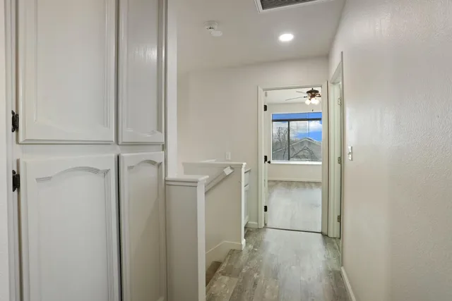 a view of hallway with wooden floor