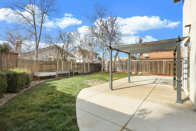 a view of a house with backyard and sitting area