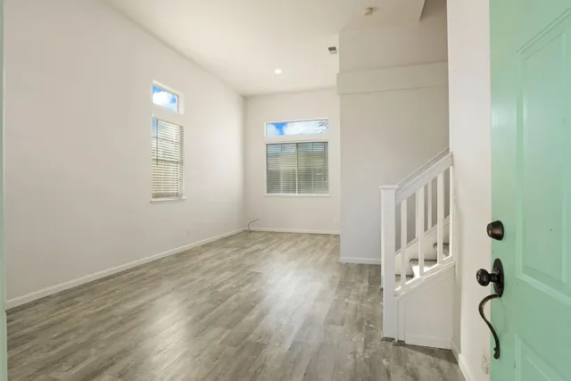 a view of an entryway with wooden floor