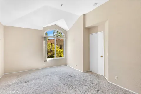 an empty room with windows and entrance