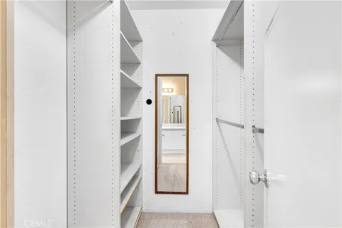 a view of a hallway with wooden floor and entryway