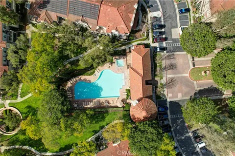an aerial view of a house with a yard and garden
