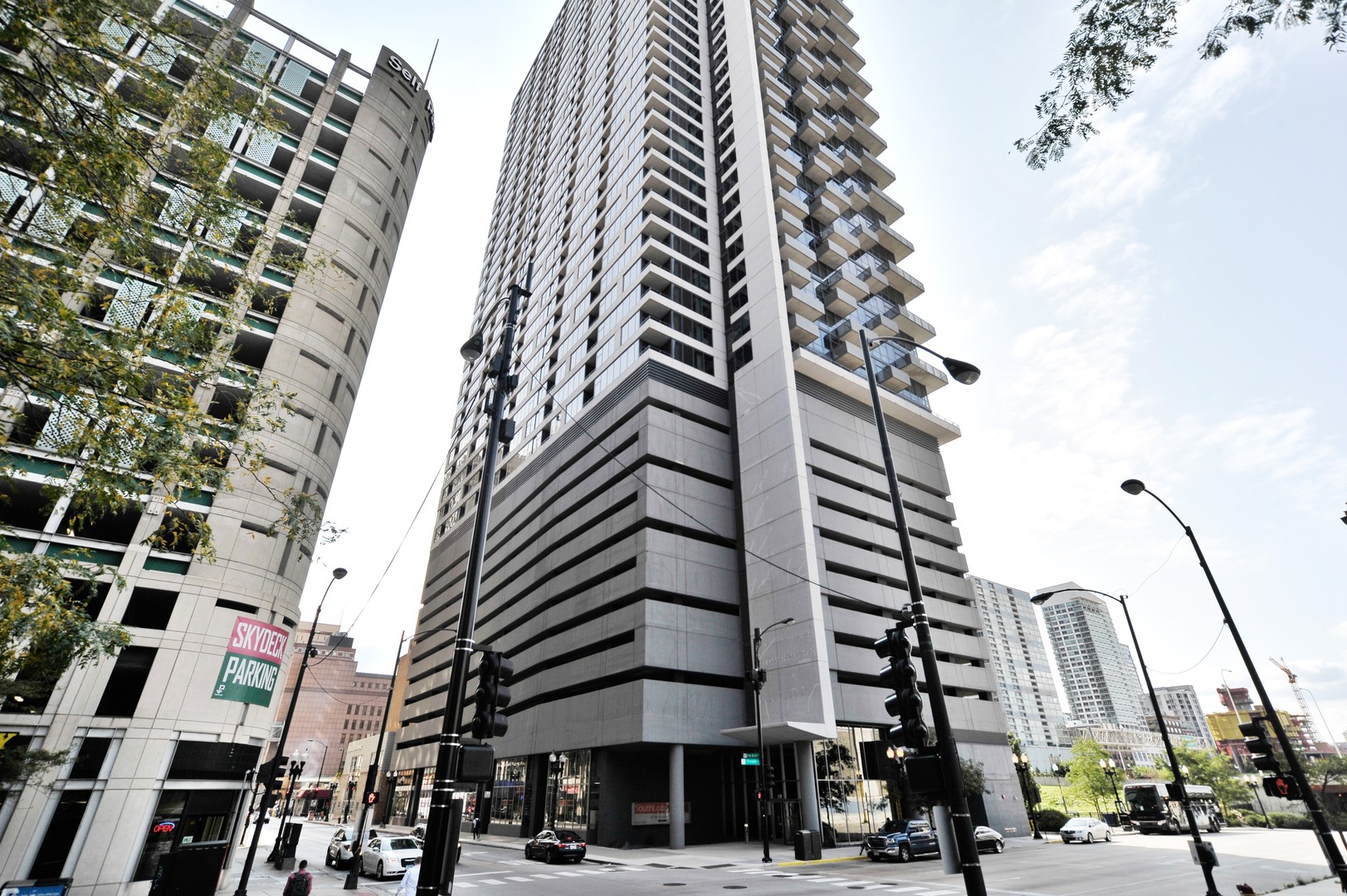 235 West Van Buren Street, Unit 3314 Chicago, IL 60607 - Photo 1 of 29 a city street lined with tall buildings and trees