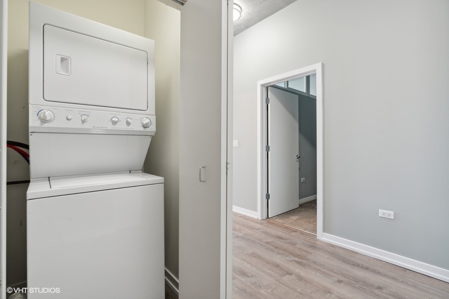 235 West Van Buren Street, Unit 3314 Chicago, IL 60607 - Photo 19 of 29 a view of washer and dryer with wooden floor