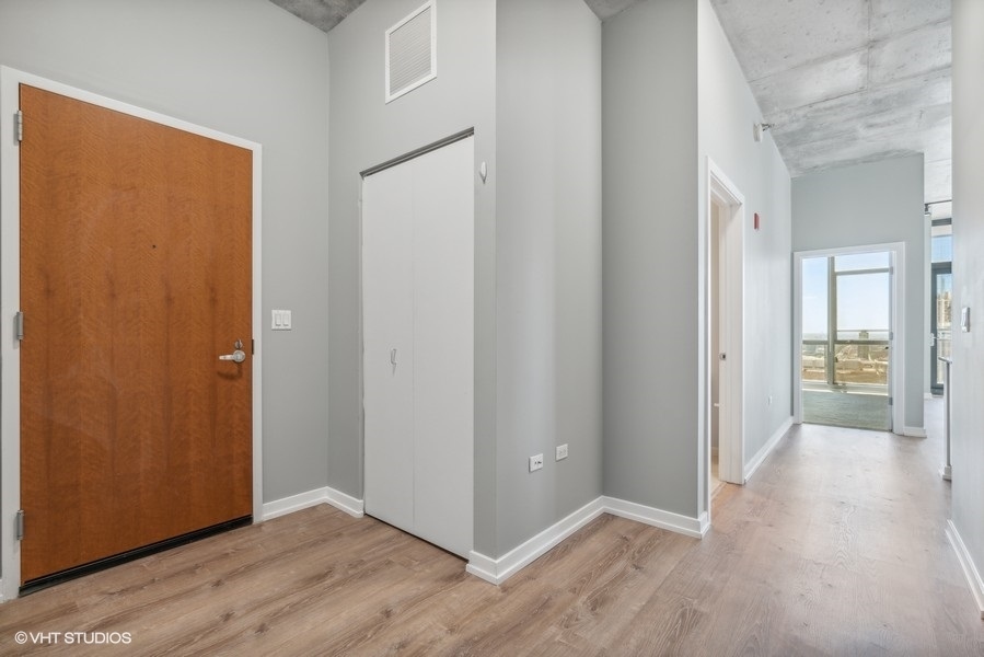 235 West Van Buren Street, Unit 3314 Chicago, IL 60607 - Photo 9 of 29 a view of a hallway with wooden floor