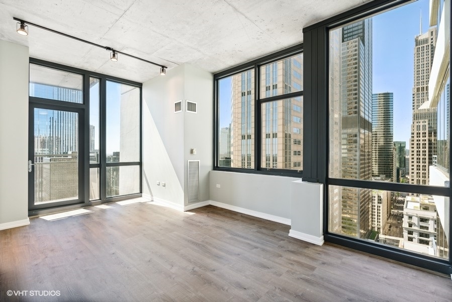 235 West Van Buren Street, Unit 3314 Chicago, IL 60607 - Photo 10 of 29 a view of an entryway with wooden floor and windows
