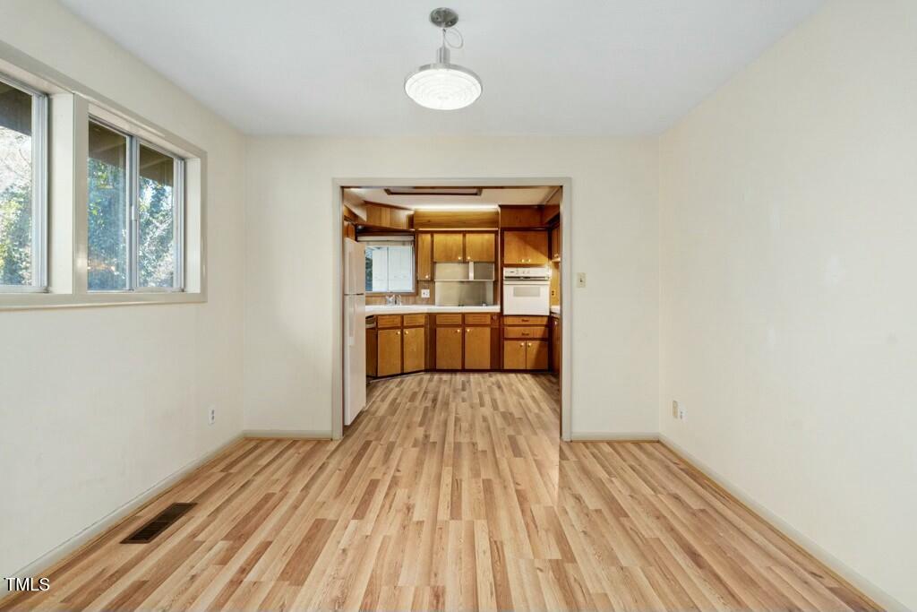 3237 Birnamwood Road Raleigh, NC 27607 - Photo 14 of 32 a view of empty room with wooden floor and fan