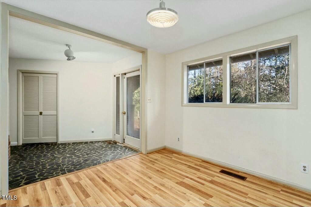 3237 Birnamwood Road Raleigh, NC 27607 - Photo 15 of 32 a view of empty room with wooden floor and fan