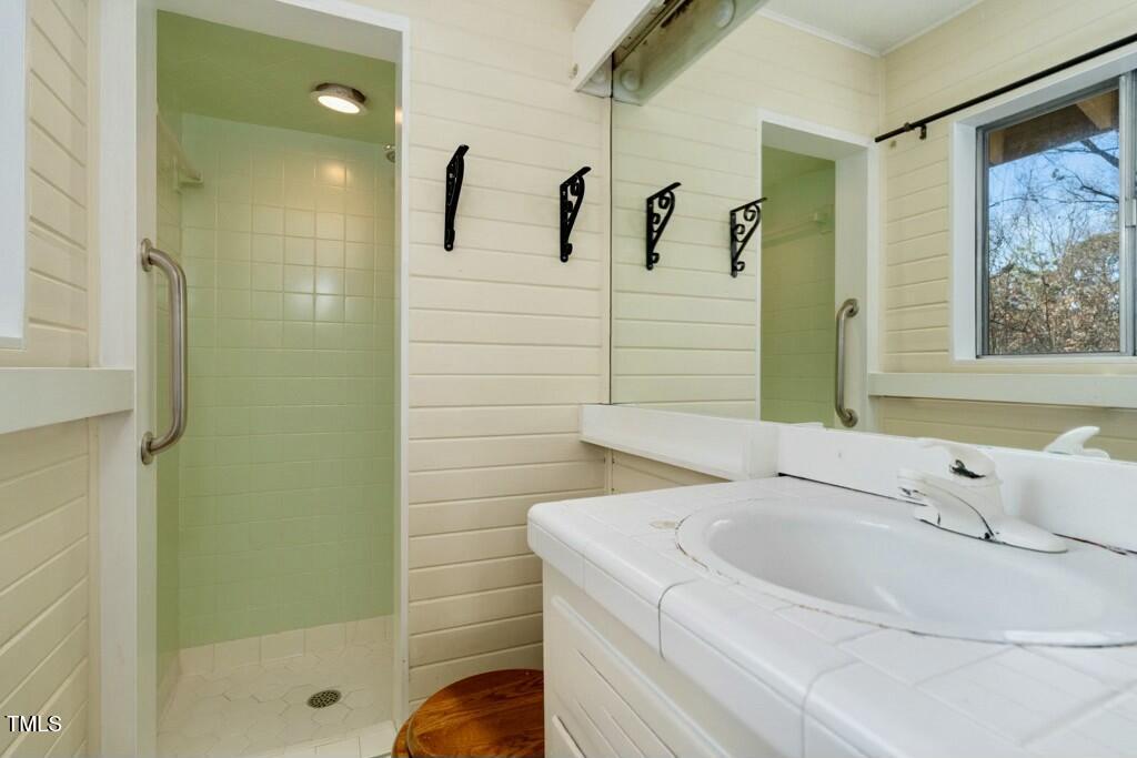 3237 Birnamwood Road Raleigh, NC 27607 - Photo 18 of 32 a bathroom with a bathtub and a shower