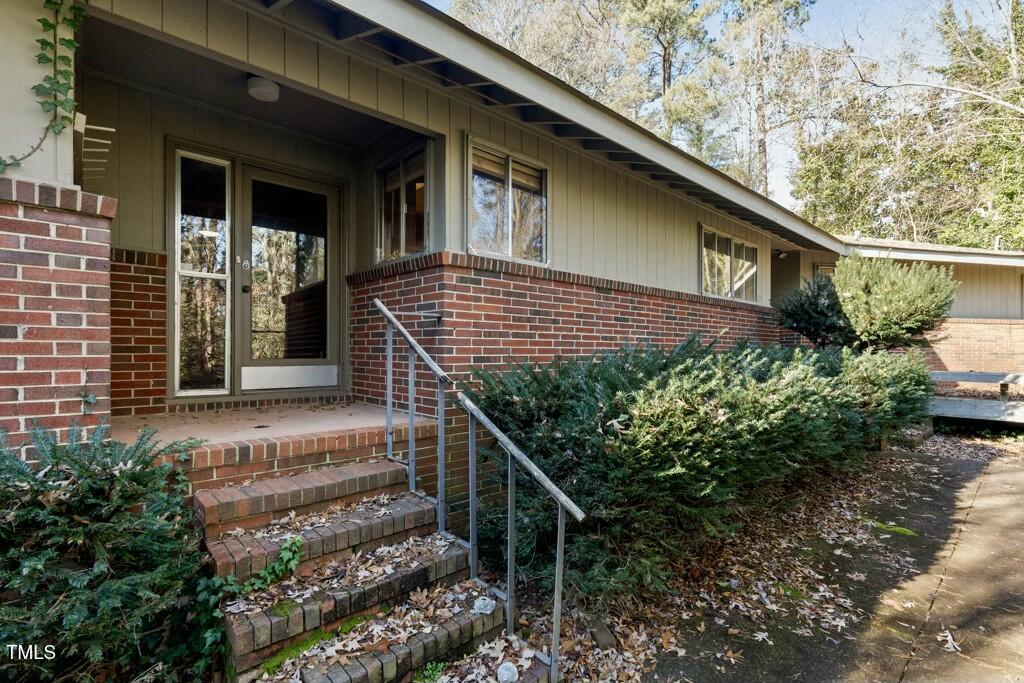 3237 Birnamwood Road Raleigh, NC 27607 - Photo 25 of 32 a view of a house with a yard next to a large tree