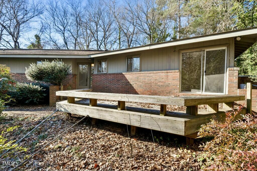 3237 Birnamwood Road Raleigh, NC 27607 - Photo 26 of 32 a view of a house with a yard siting area and garden