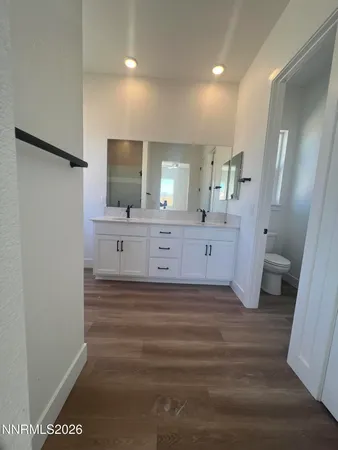 a bathroom with a sink a mirror and a toilet