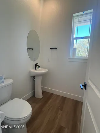 a bathroom with a toilet sink and a window