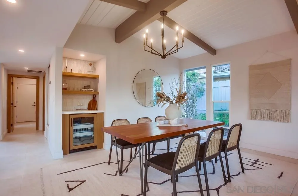 5878 Soledad Road La Jolla, CA 92037 - Photo 23 of 74 a view of a dining room with furniture a chandelier and wooden floor