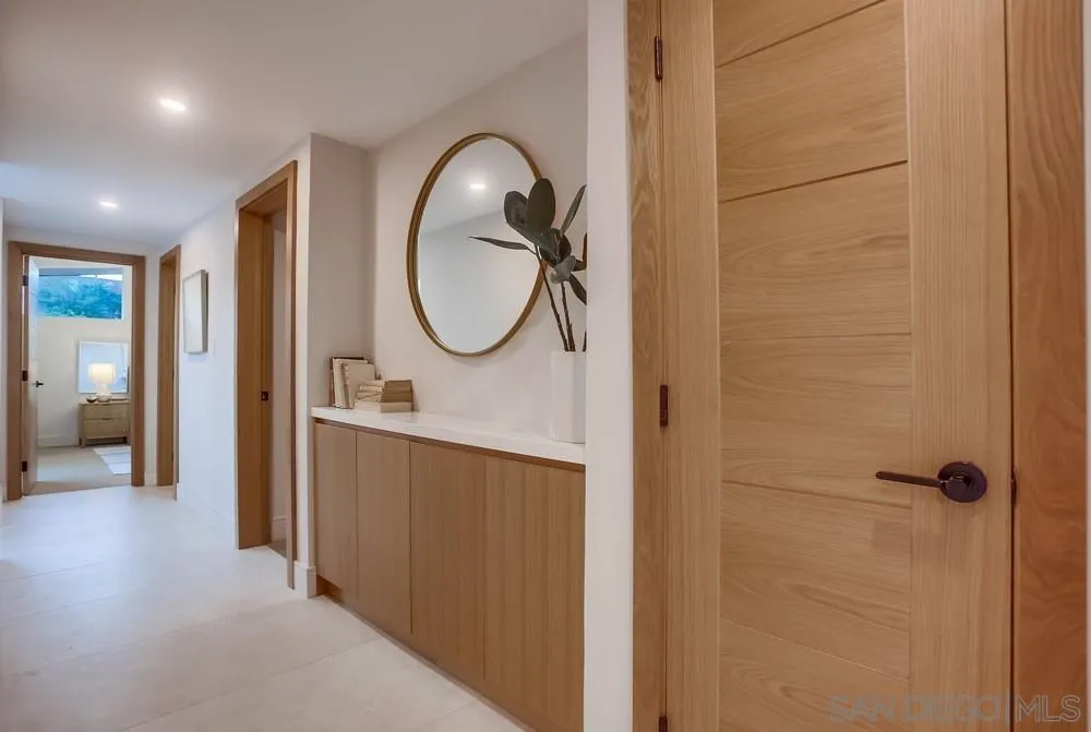 5878 Soledad Road La Jolla, CA 92037 - Photo 25 of 74 a bathroom with a mirror and a shower