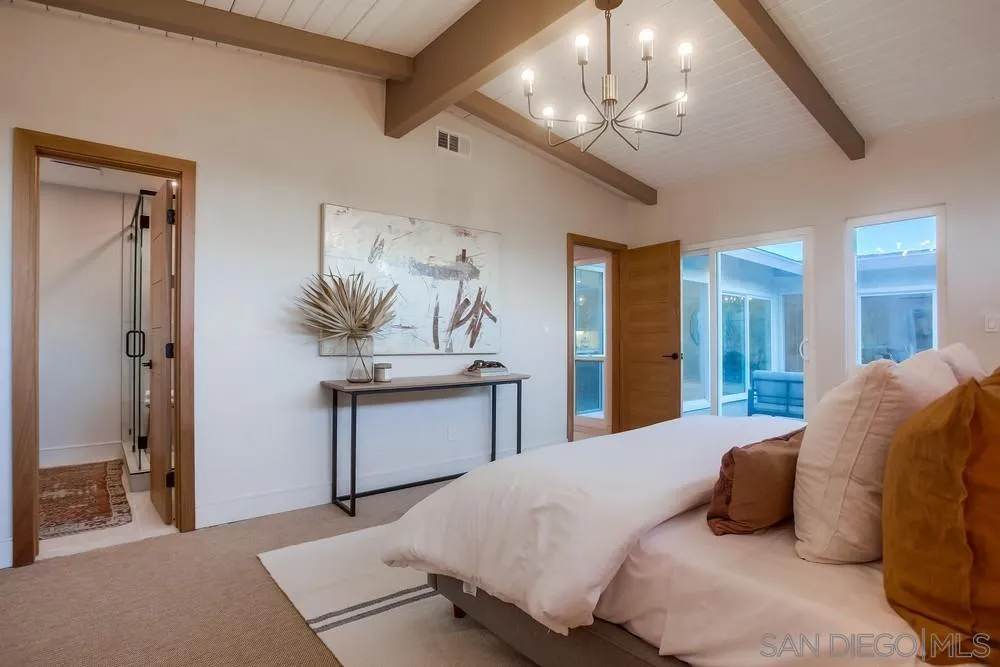 5878 Soledad Road La Jolla, CA 92037 - Photo 29 of 74 a bedroom with a bed and ceiling fan