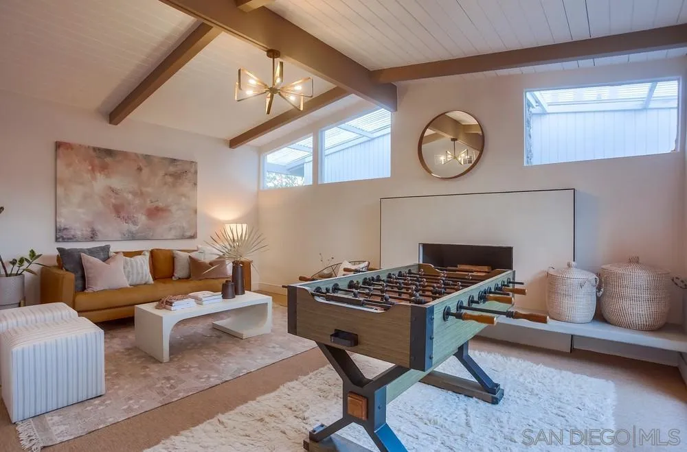 5878 Soledad Road La Jolla, CA 92037 - Photo 32 of 74 a living room with furniture a clock and a fireplace