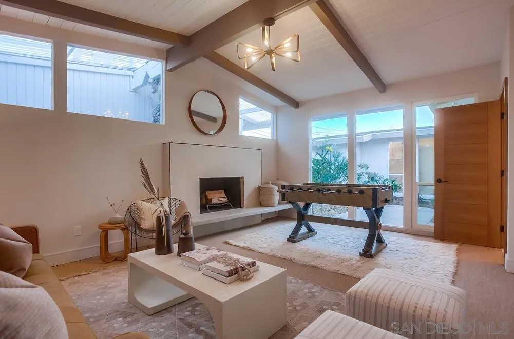5878 Soledad Road La Jolla, CA 92037 - Photo 33 of 74 a living room with furniture a rug and a fireplace