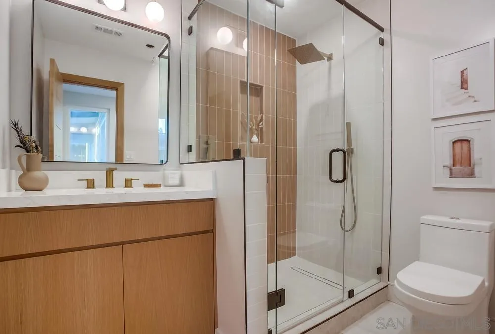 5878 Soledad Road La Jolla, CA 92037 - Photo 34 of 74 a bathroom with a shower sink mirror and toilet