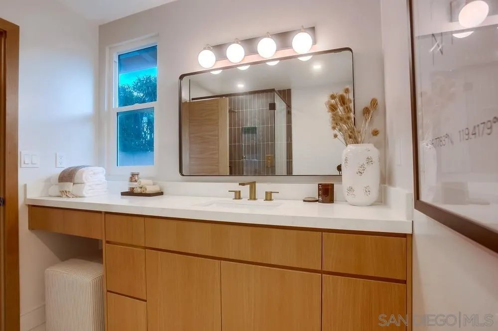 5878 Soledad Road La Jolla, CA 92037 - Photo 41 of 74 a bathroom with a sink and a mirror
