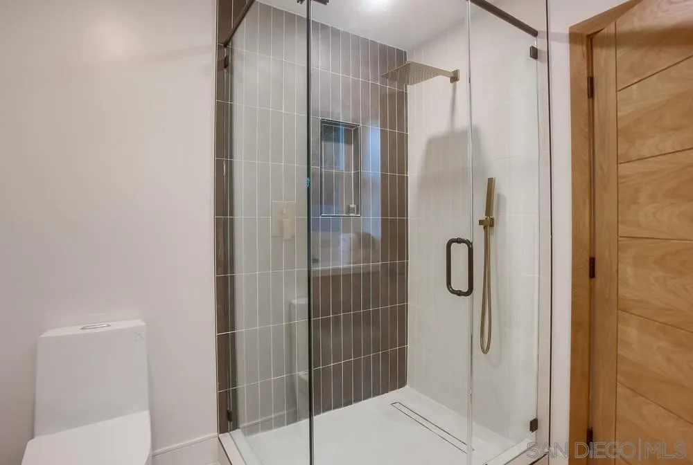 5878 Soledad Road La Jolla, CA 92037 - Photo 42 of 74 a bathroom with a glass shower door