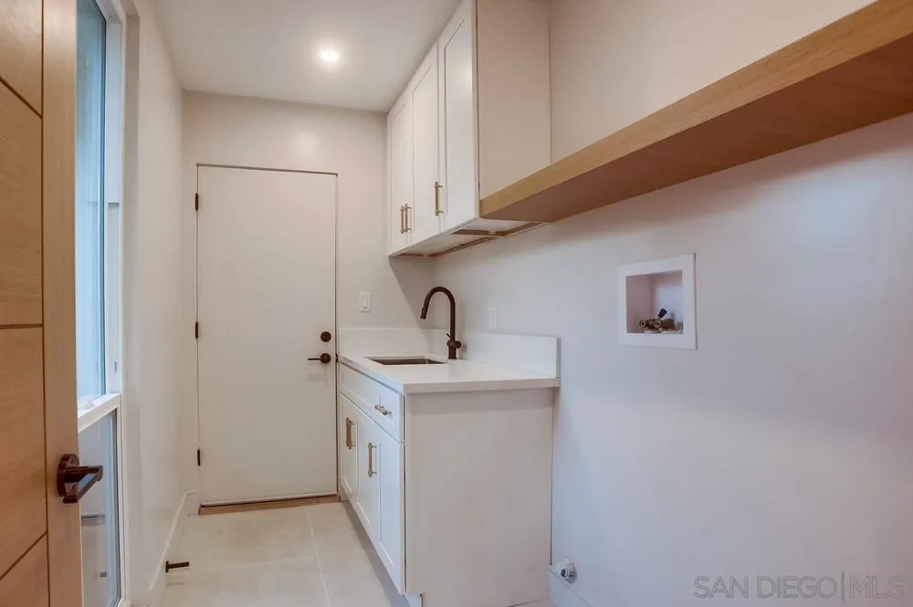 5878 Soledad Road La Jolla, CA 92037 - Photo 43 of 74 a kitchen with a sink and cabinets