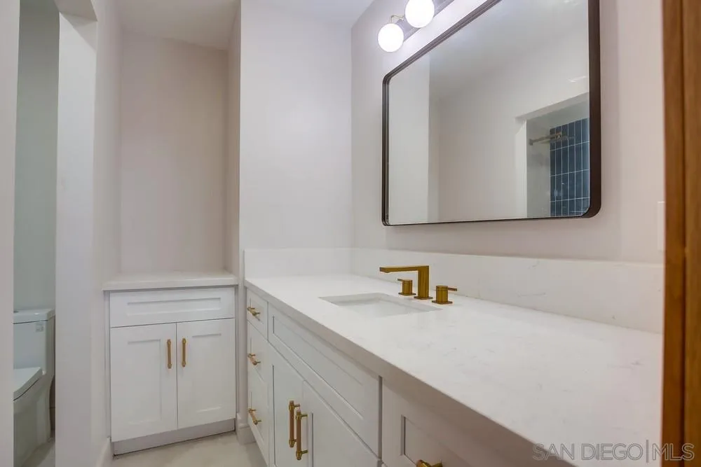 5878 Soledad Road La Jolla, CA 92037 - Photo 52 of 74 a bathroom with a sink and a mirror