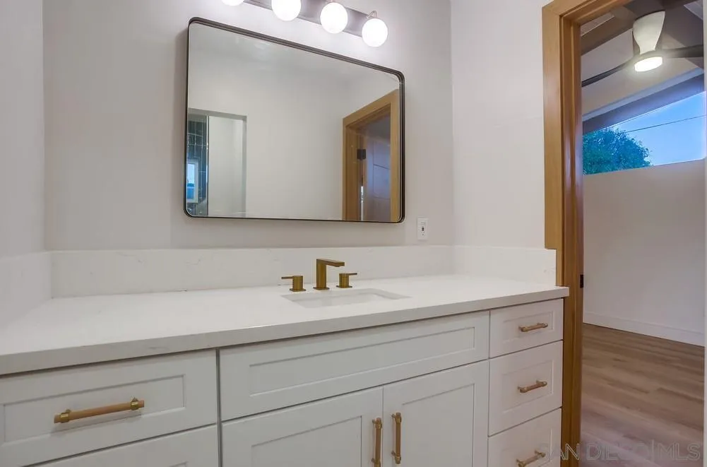5878 Soledad Road La Jolla, CA 92037 - Photo 53 of 74 a bathroom with a sink and a mirror