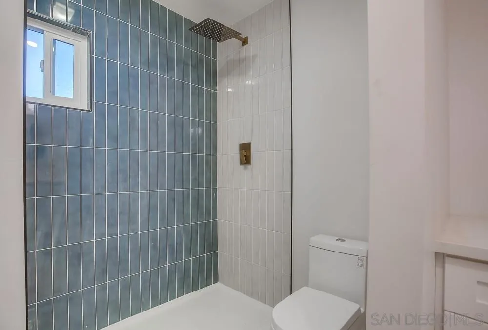 5878 Soledad Road La Jolla, CA 92037 - Photo 54 of 74 a bathroom with a toilet and shower
