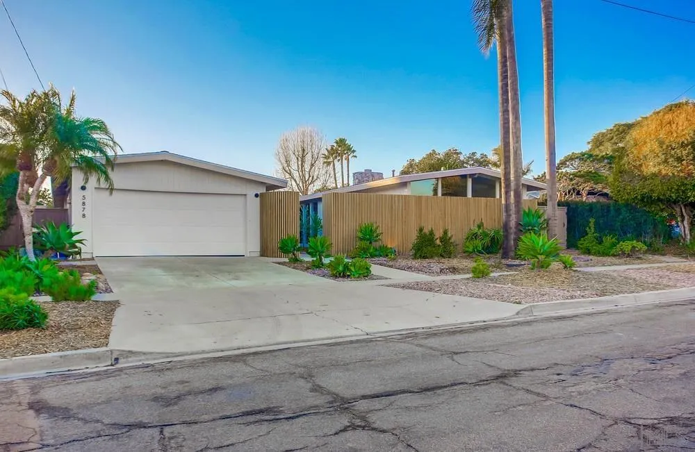 5878 Soledad Road La Jolla, CA 92037 - Photo 57 of 74 a front view of a house with a yard and a garage