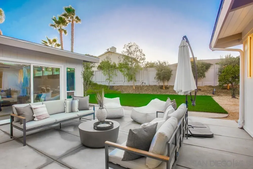 5878 Soledad Road La Jolla, CA 92037 - Photo 65 of 74 a view of a patio with couches potted plants and a big yard