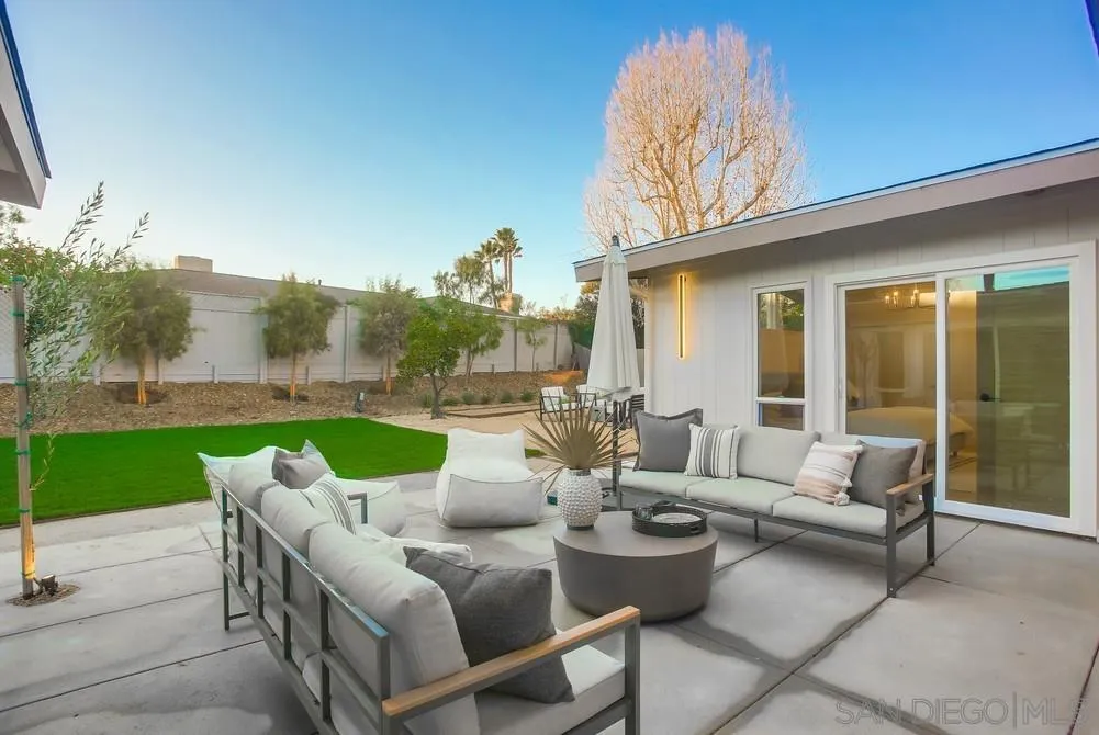 5878 Soledad Road La Jolla, CA 92037 - Photo 67 of 74 a view of a patio with couches potted plants and a big yard