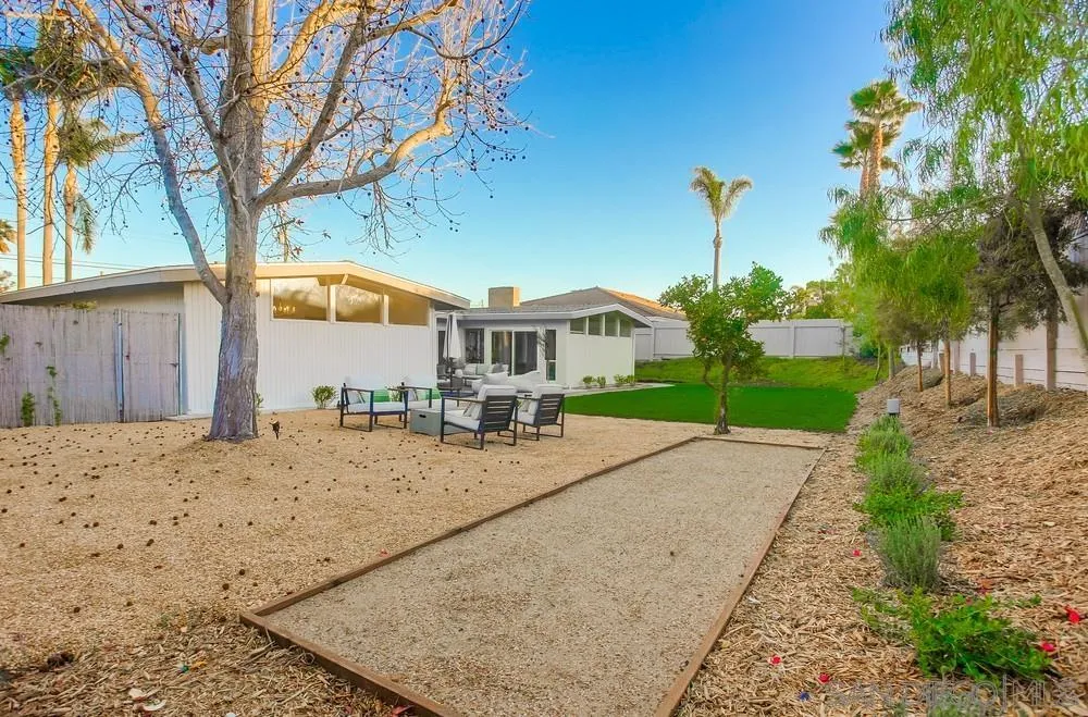 5878 Soledad Road La Jolla, CA 92037 - Photo 71 of 74 a front view of a house with a yard and garage