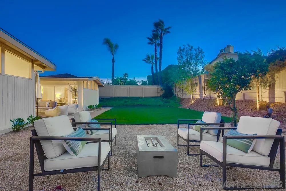 5878 Soledad Road La Jolla, CA 92037 - Photo 10 of 74 a view of a patio with table and chairs potted plants and a palm tree