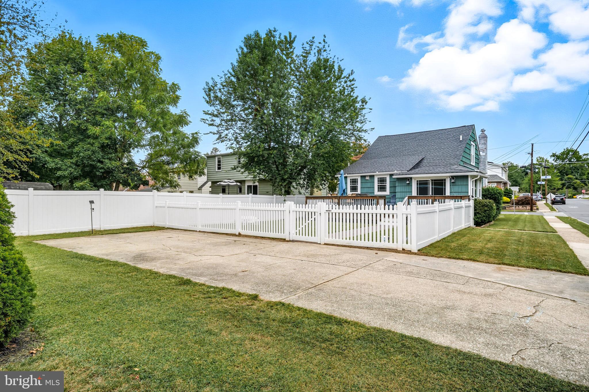1600 West High Street Haddon Heights, NJ 08035 - Photo 41 of 46 a house view with swimming pool and trees in the background