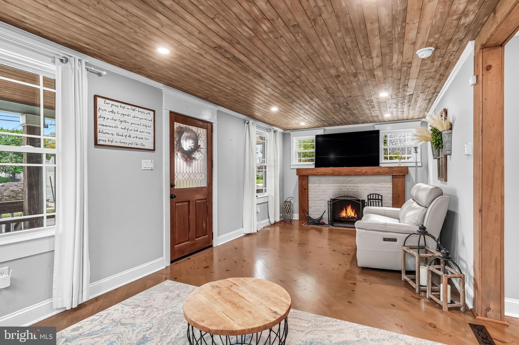 1600 West High Street Haddon Heights, NJ 08035 - Photo 7 of 46 a living room with furniture a fireplace and a flat screen tv