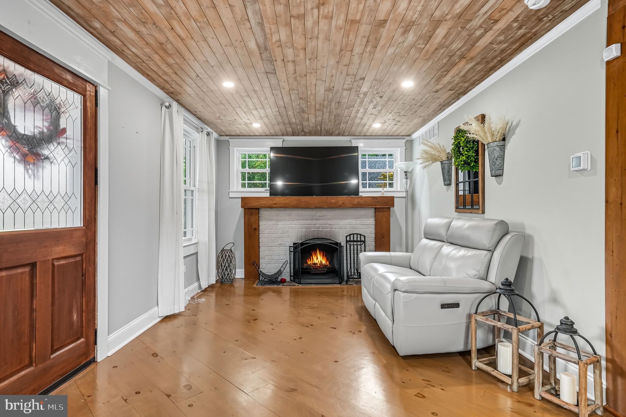 1600 West High Street Haddon Heights, NJ 08035 - Photo 8 of 46 a living room with furniture a fireplace and a flat screen tv
