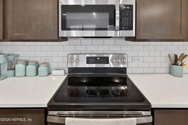 a kitchen with a stove and a microwave