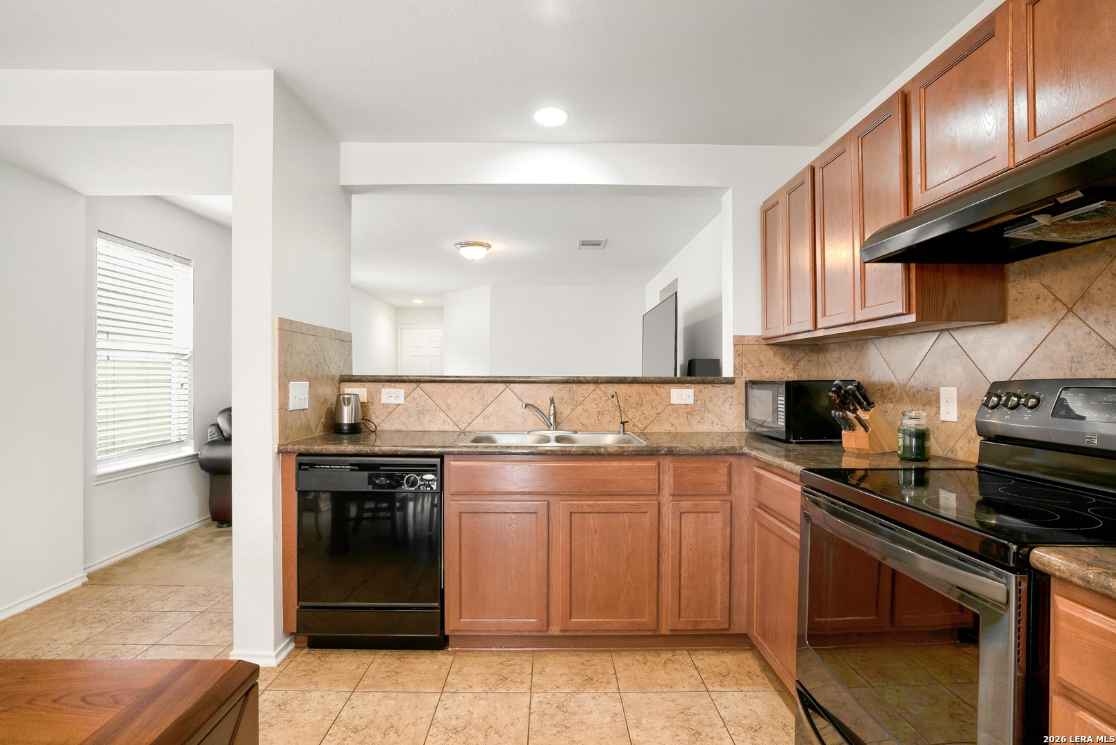 2306 Howry Drive Georgetown, TX 78626 - Photo 5 of 15 a kitchen with stainless steel appliances a stove sink and cabinets