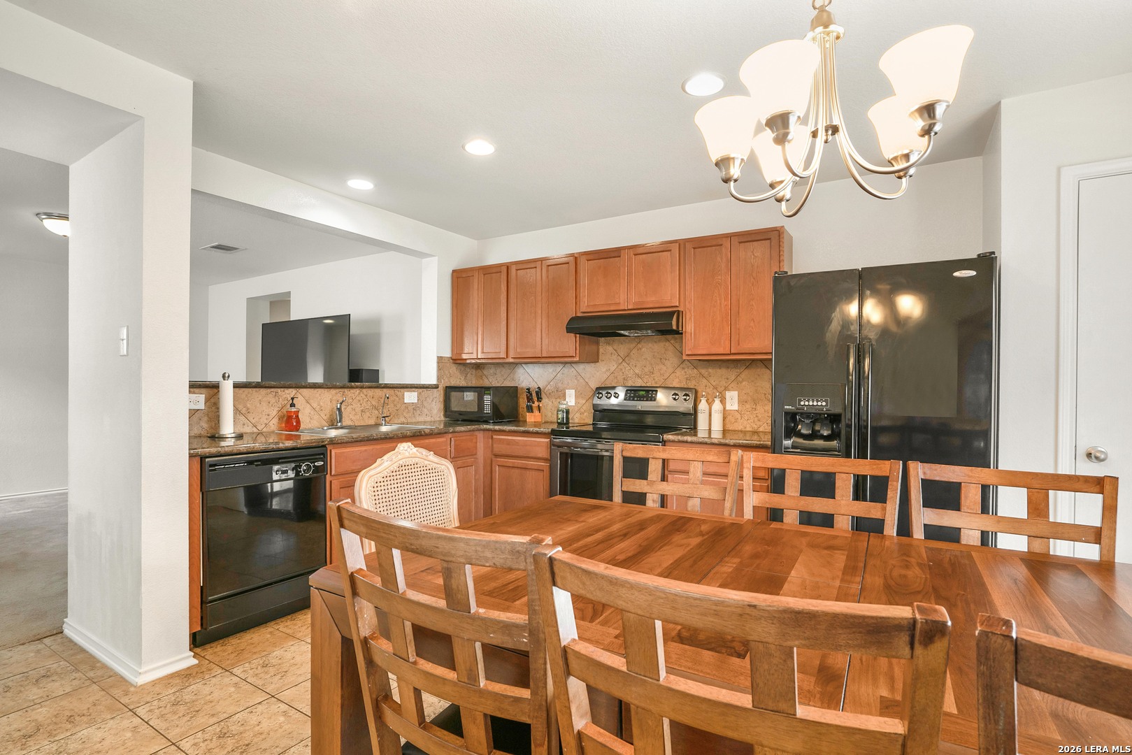 2306 Howry Drive Georgetown, TX 78626 - Photo 7 of 15 a kitchen with kitchen island granite countertop a sink cabinets and stainless steel appliances