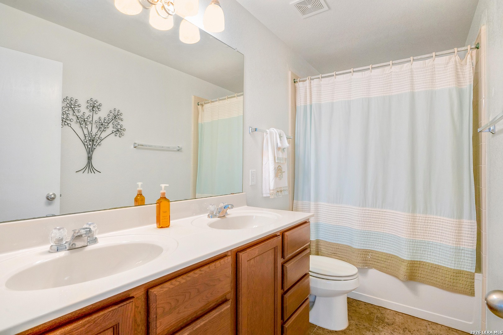 2306 Howry Drive Georgetown, TX 78626 - Photo 10 of 15 a bathroom with a sink a toilet and shower curtain