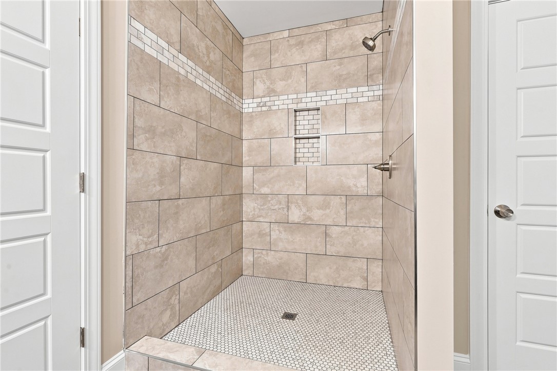 216 West Halfway Branch Road Walhalla, SC 29691 - Photo 15 of 41 Elegantly tiled walk-in shower features built-in niches and contrasting mosaic floor accents.