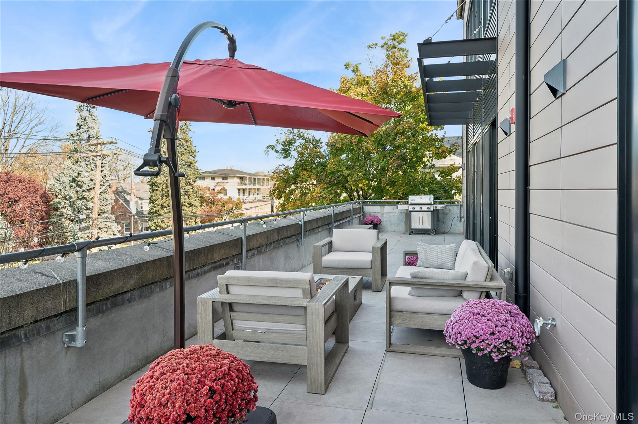a balcony with furniture and a potted plant