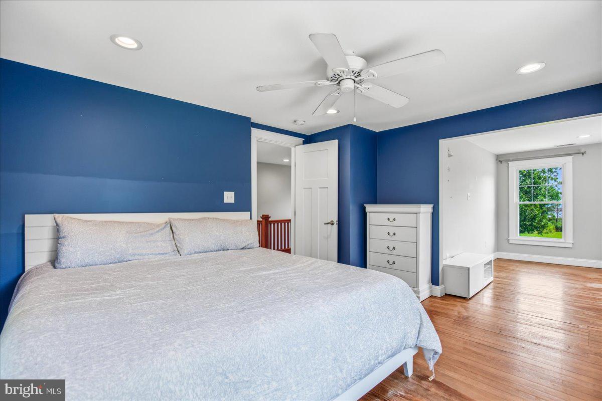 16146 Thomas Road Piney Point, MD 20674 - Photo 49 of 70 a bedroom with a large bed and a chandelier